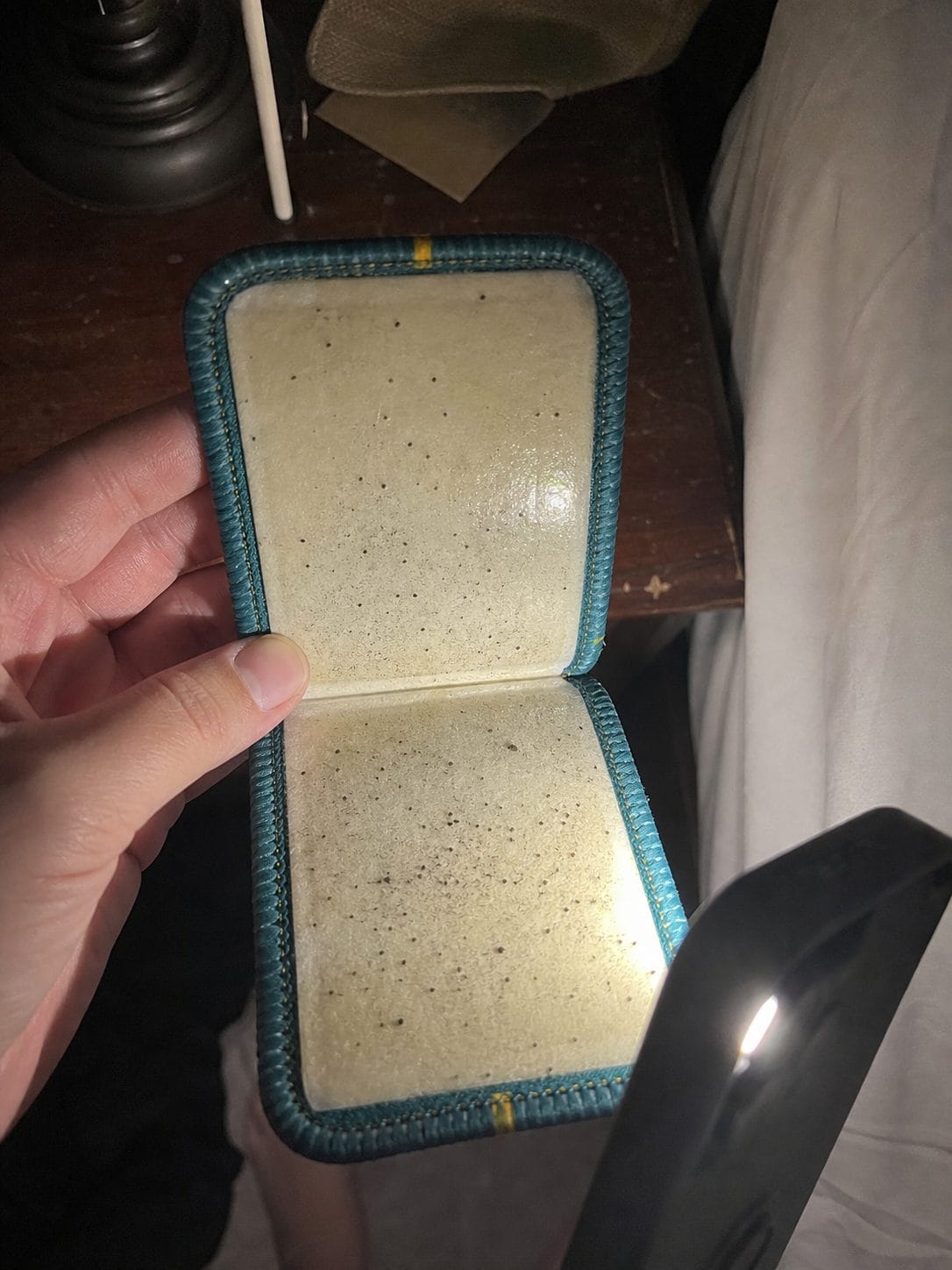Inside of a used CaptureCard showing visible black dots caught on the adhesive