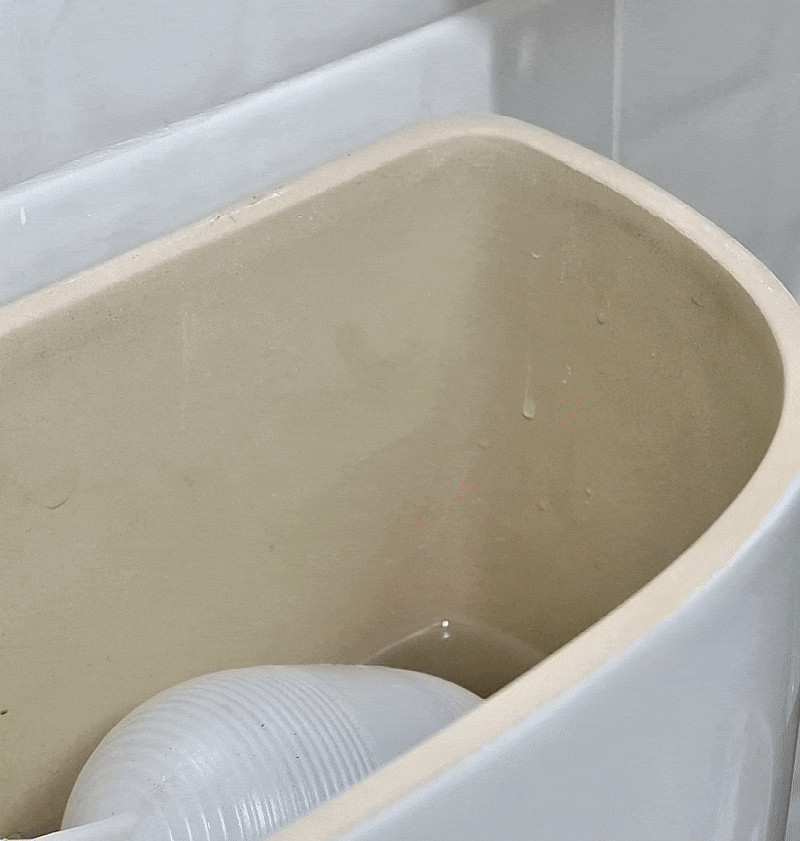 Clipping the TrueClean dispenser into the toilet tank